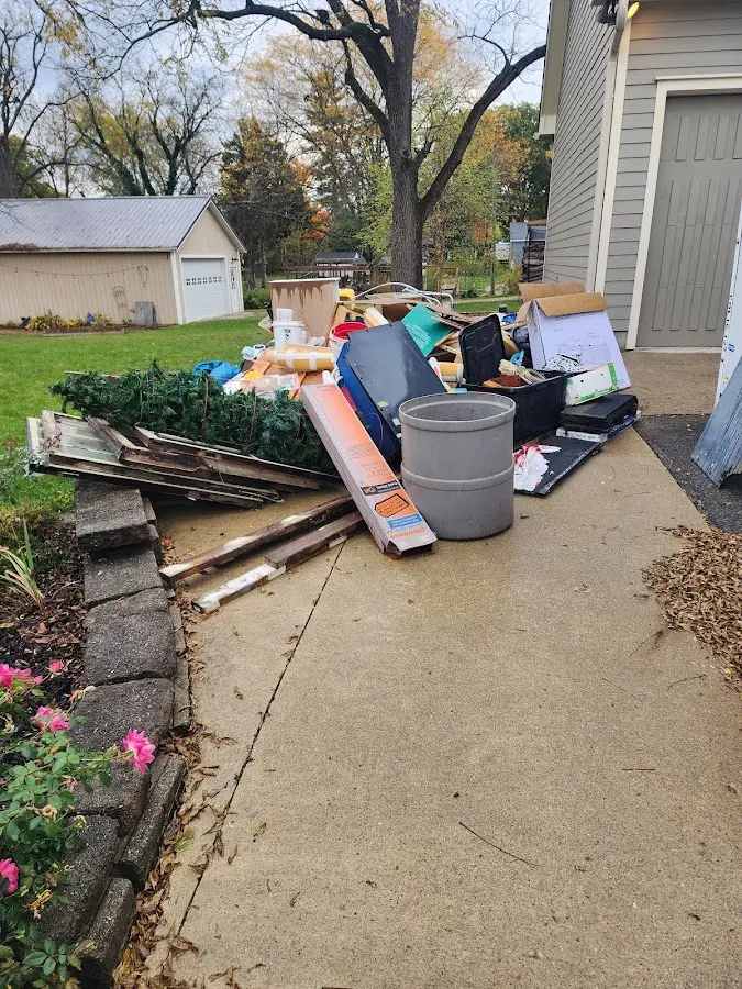 Dumpster being loaded with debris for Estate Cleanout Dumpster Rental in Sutherlin